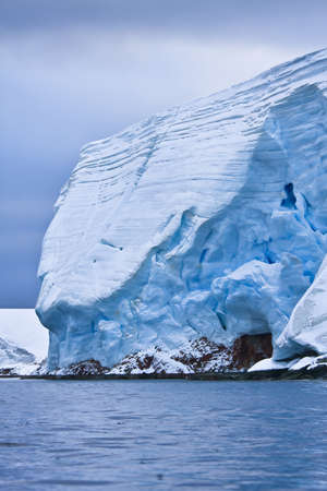 Huge Antarctic iceberg in the snowの写真素材