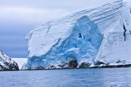 Huge Antarctic iceberg in the snowの写真素材