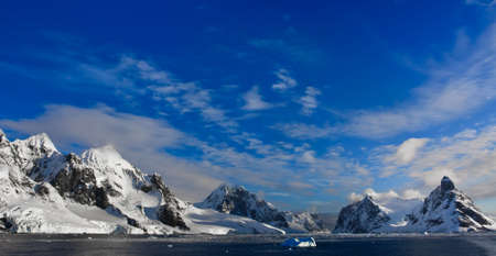 Beautiful snow-capped mountains against the blue sky in Antarcticaの写真素材