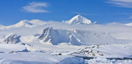 Beautiful snow-capped mountains against the blue skyの写真素材