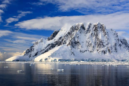 Beautiful snow-capped mountains against the blue sky in Antarcticaの写真素材