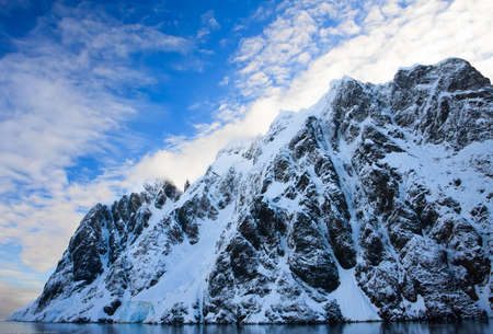 Beautiful snow-capped mountains against the blue sky in Antarcticaの写真素材