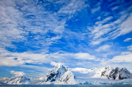 Beautiful snow-capped mountains against the blue skyの写真素材