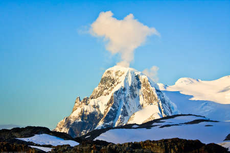 Beautiful snow-capped mountains against the blue sky in Antarcticaの写真素材