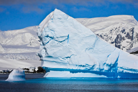 Huge iceberg in Antarctica, clear sky, azure water, sunny day