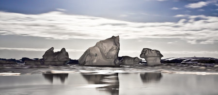 Summer night in Antarctica.Icebergs floating in the moonlightの写真素材