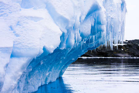 Reflection of the Antarctic Glacier with iciclesの写真素材