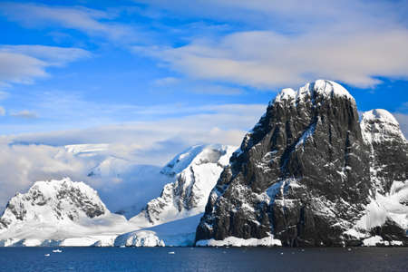 Beautiful snow-capped mountains against the blue sky in Antarcticaの写真素材