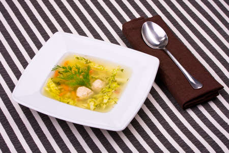 vegetable soup in white bowl with a spoonの写真素材
