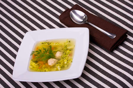 vegetable soup in white bowl with a spoonの写真素材