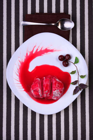 curd dessert with cherry jam on white plateの写真素材