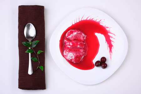 curd dessert with cherry jam on white plateの写真素材