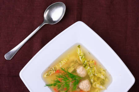 vegetable soup in white bowl with a spoonの写真素材
