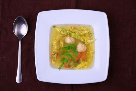 vegetable soup in white bowl with a spoonの写真素材