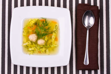 vegetable soup in white bowl with a spoonの写真素材