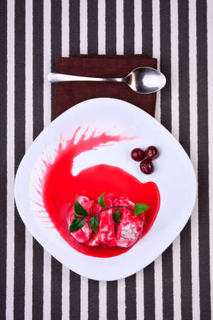 curd dessert with cherry jam on white plateの写真素材