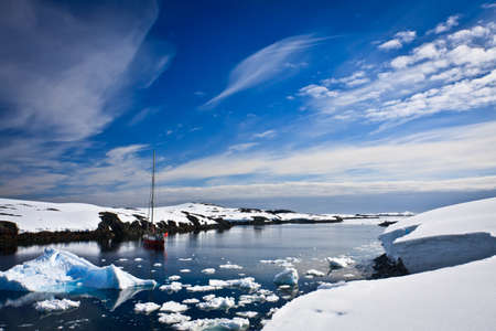 yacht sailing among the glaciers in Antarcticaの写真素材