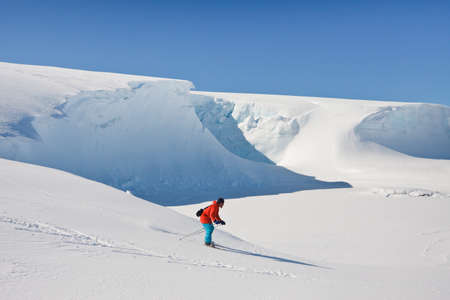 Man moves on skis. Glacier in background. Antarcticaの写真素材