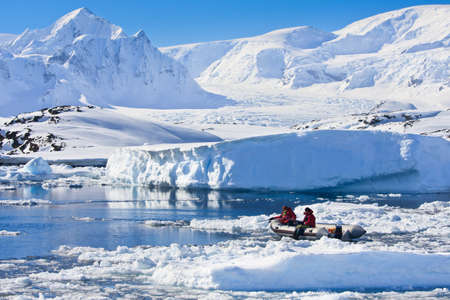 two men in the boat in Antarcticaの写真素材