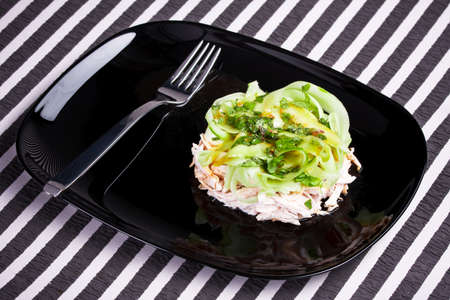 Vitamin salad with lime in the black dishの写真素材