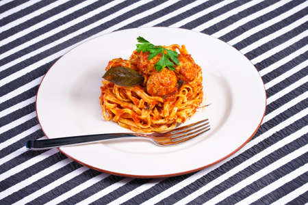 Spaghetti with meatballs on a white plateの写真素材