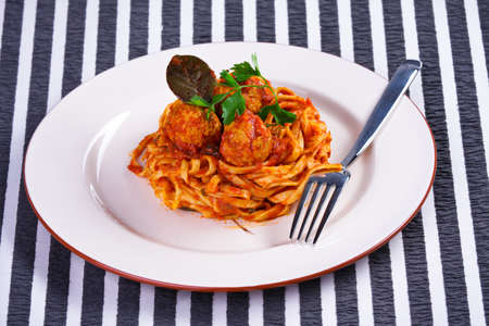 Spaghetti with meatballs on a white plateの写真素材