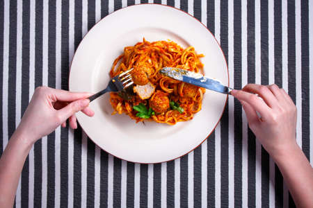 Spaghetti with meatballs on a white plateの写真素材