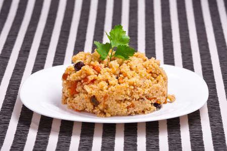 delicious couscous with chicken on a striped backgroundの写真素材