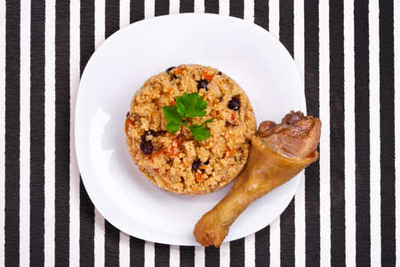 delicious couscous with chicken on a striped backgroundの写真素材
