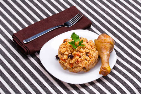 delicious couscous with chicken on a striped backgroundの写真素材