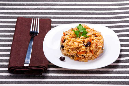 delicious couscous with chicken on a striped backgroundの写真素材