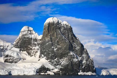 Beautiful snow-capped mountains against the blue sky in Antarcticaの写真素材