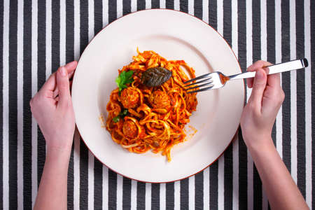 Spaghetti with meatballs on a white plateの写真素材