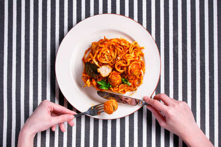 Spaghetti with meatballs on a white plateの写真素材