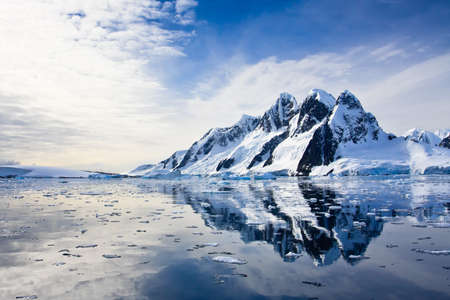 Beautiful snow-capped mountains against the blue skyの写真素材