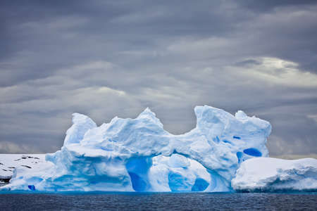 Antarctic iceberg in the snow. Beautiful winter background.の写真素材