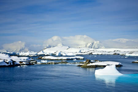 Beautiful snow-capped mountains against the blue sky in Antarcticaの写真素材