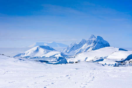 Beautiful snow-capped mountains against the blue sky in Antarcticaの写真素材