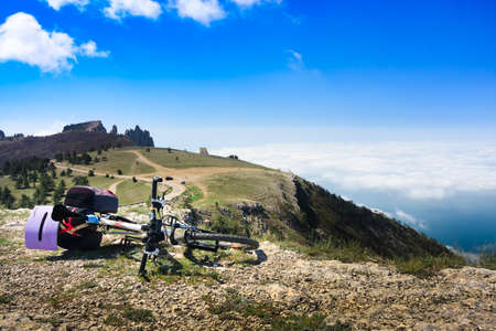 Bike over the precipice in the mountainsの写真素材