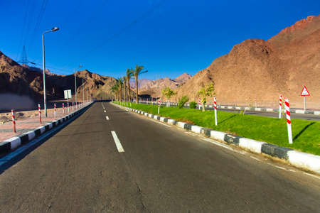 Road through the desert and sandy hillsの写真素材