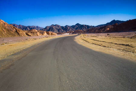 Road through the desert and sandy hillsの写真素材