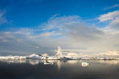 Beautiful snow-capped mountains against the blue sky in Antarcticaの写真素材