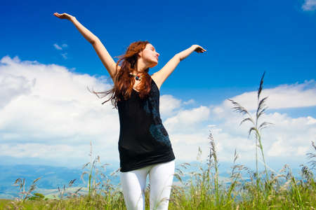 Beautiful young woman under blue sky. Portraitの写真素材