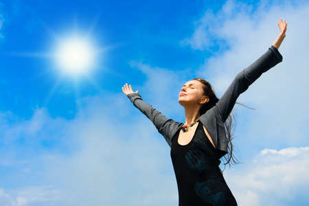 Beautiful young woman under blue sky. Portraitの写真素材