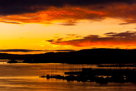 Cloudy orange sunset over sea. Beautiful landscapeの写真素材