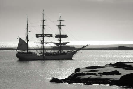 Sailing ship at dawn among the icebergs in Antarcticaの写真素材