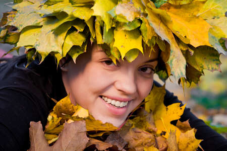 Portrait of beautiful girl in wreath of leavesの写真素材