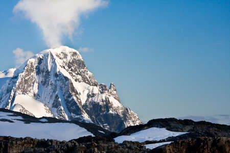Beautiful snow-capped mountains against the blue sky in Antarcticaの写真素材