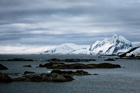 Beautiful snow-capped mountains against the blue sky in Antarcticaの写真素材