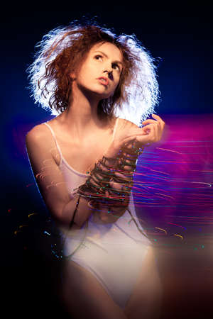 Young beautiful girl in the fires in motionの写真素材